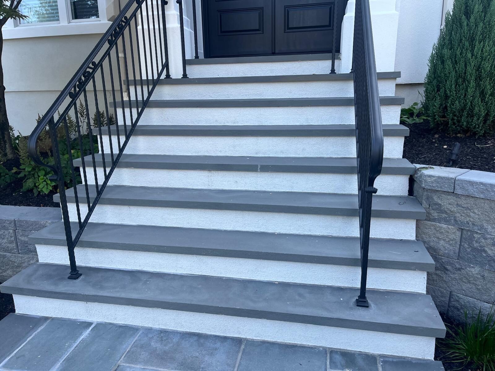 Bluestone front entry steps with wrought iron railings