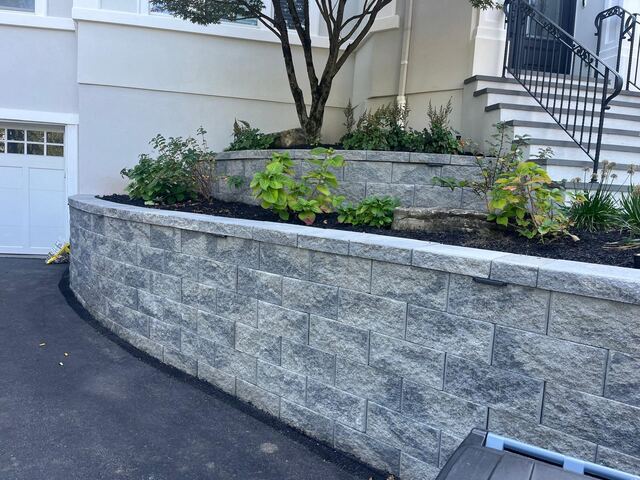 Two-tier curved block retaining wall with new planting beds