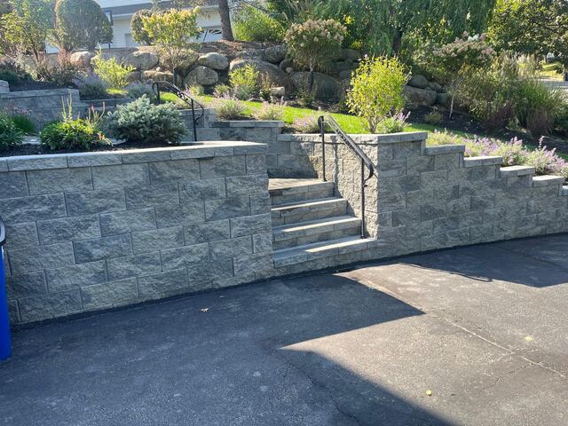 Stone block steps through retaining wall bordered by lavender